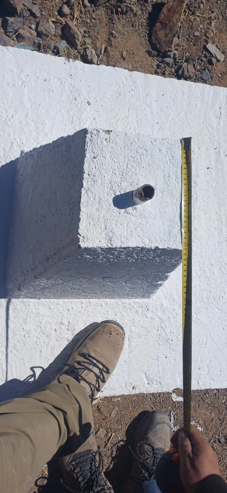 Topógrafo de GEO CORS midiendo un hito de mensura HM Guadalupe III con huincha certificada sobre monolito de hormigón en Vallenar